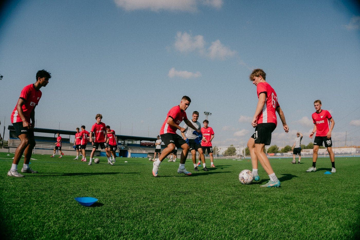Eture High School players training on the grass at the Sant Jordi campus
