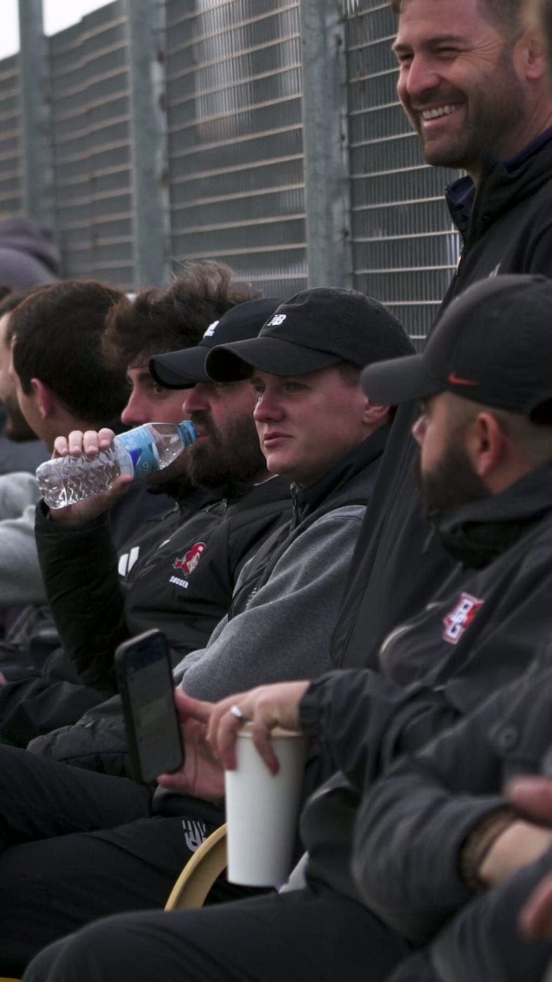 NCAA coaches watching a session from the touchline