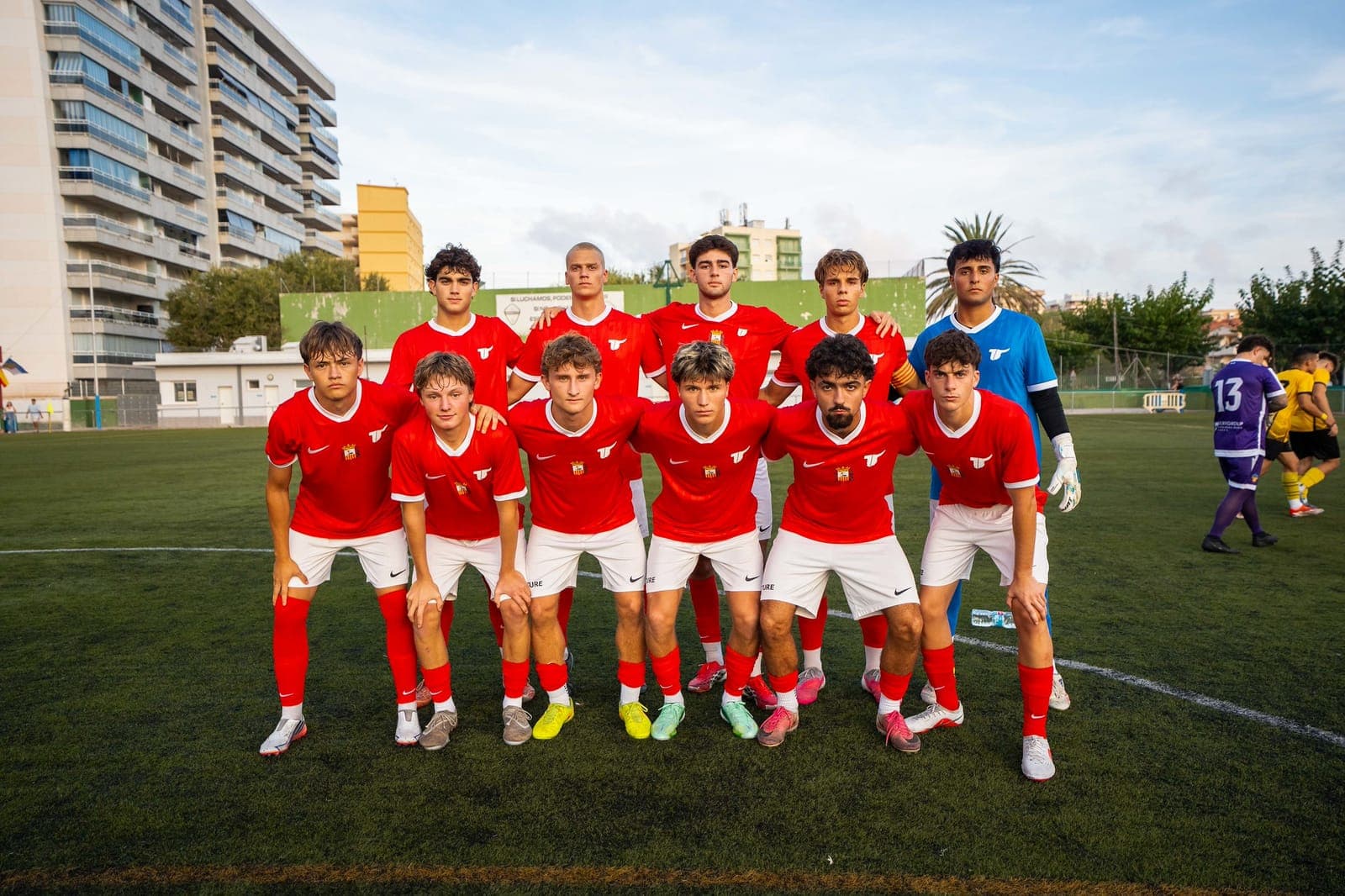 The Eture FC starting eleven in red before a league match in Spain