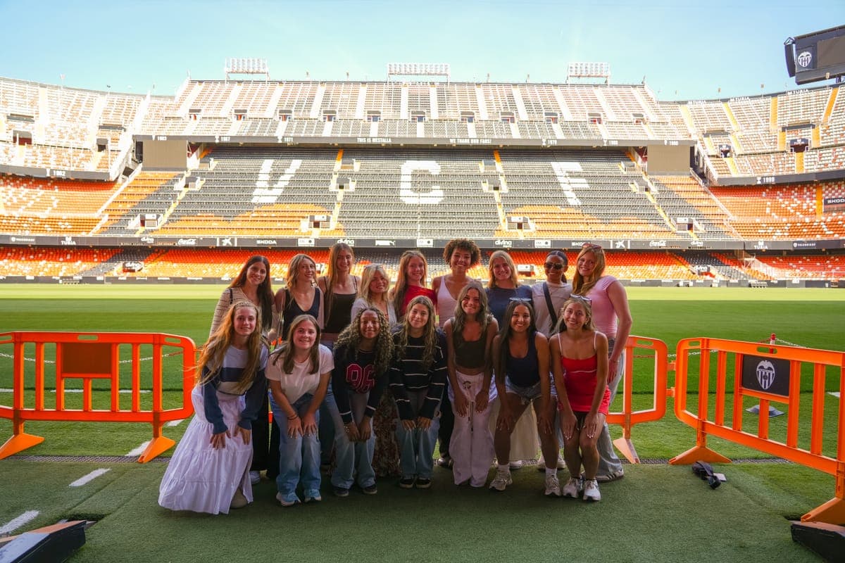 The group on the pitch of an empty stadium