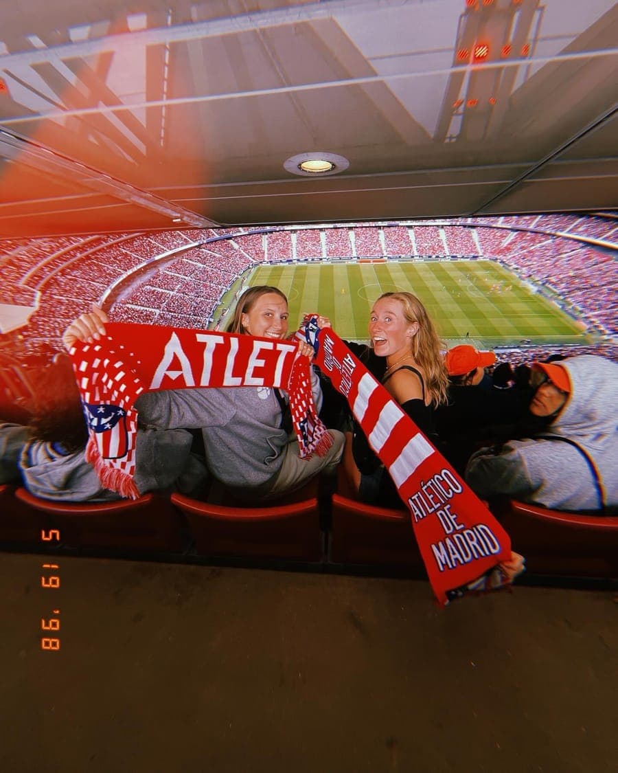 Two players holding a scarf in the stands at a LaLiga match